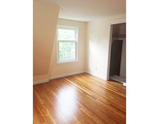52 Meadowbrook Road Brookline, MA 02467 - Photo 17 of 20 a view of an empty room with wooden floor and a window