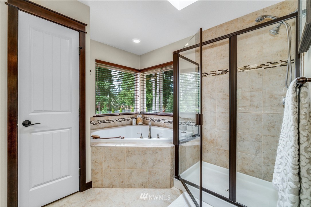 23522 2nd Avenue Southeast Bothell, WA 98021 - Photo 22 of 38 a bathroom with a tub and a shower