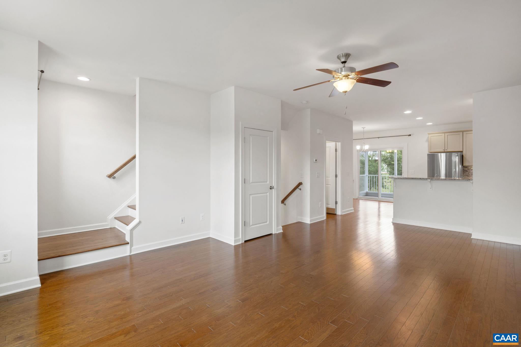 435 Rolkin Road Charlottesville, VA 22911 - Photo 14 of 56 a view of an empty room with wooden floor and a ceiling fan