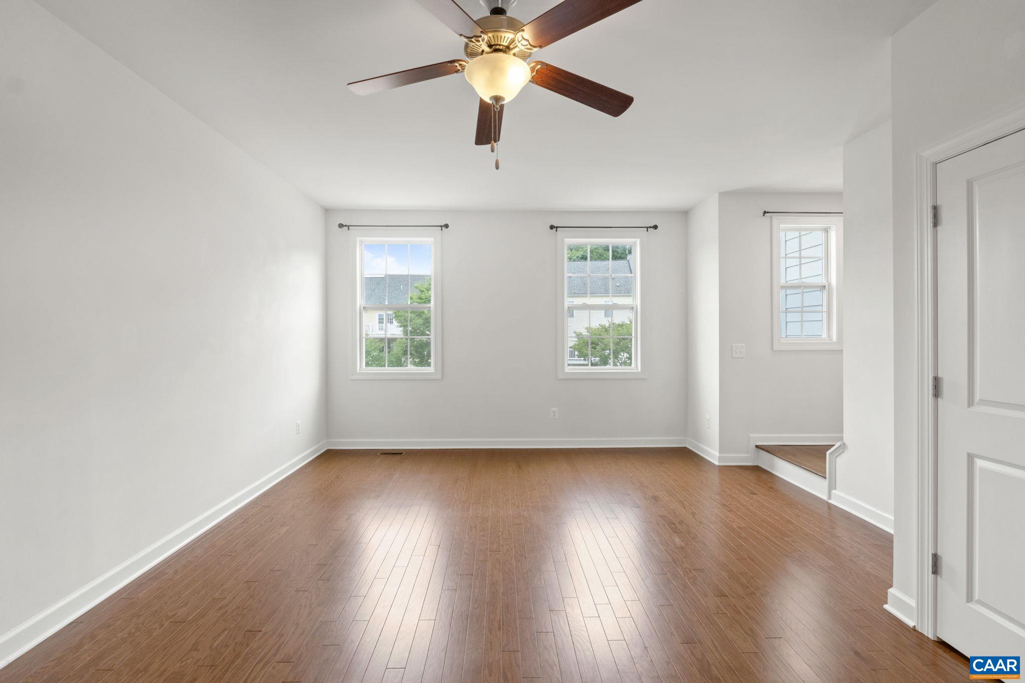 435 Rolkin Road Charlottesville, VA 22911 - Photo 15 of 56 an empty room with wooden floor chandelier fan and windows