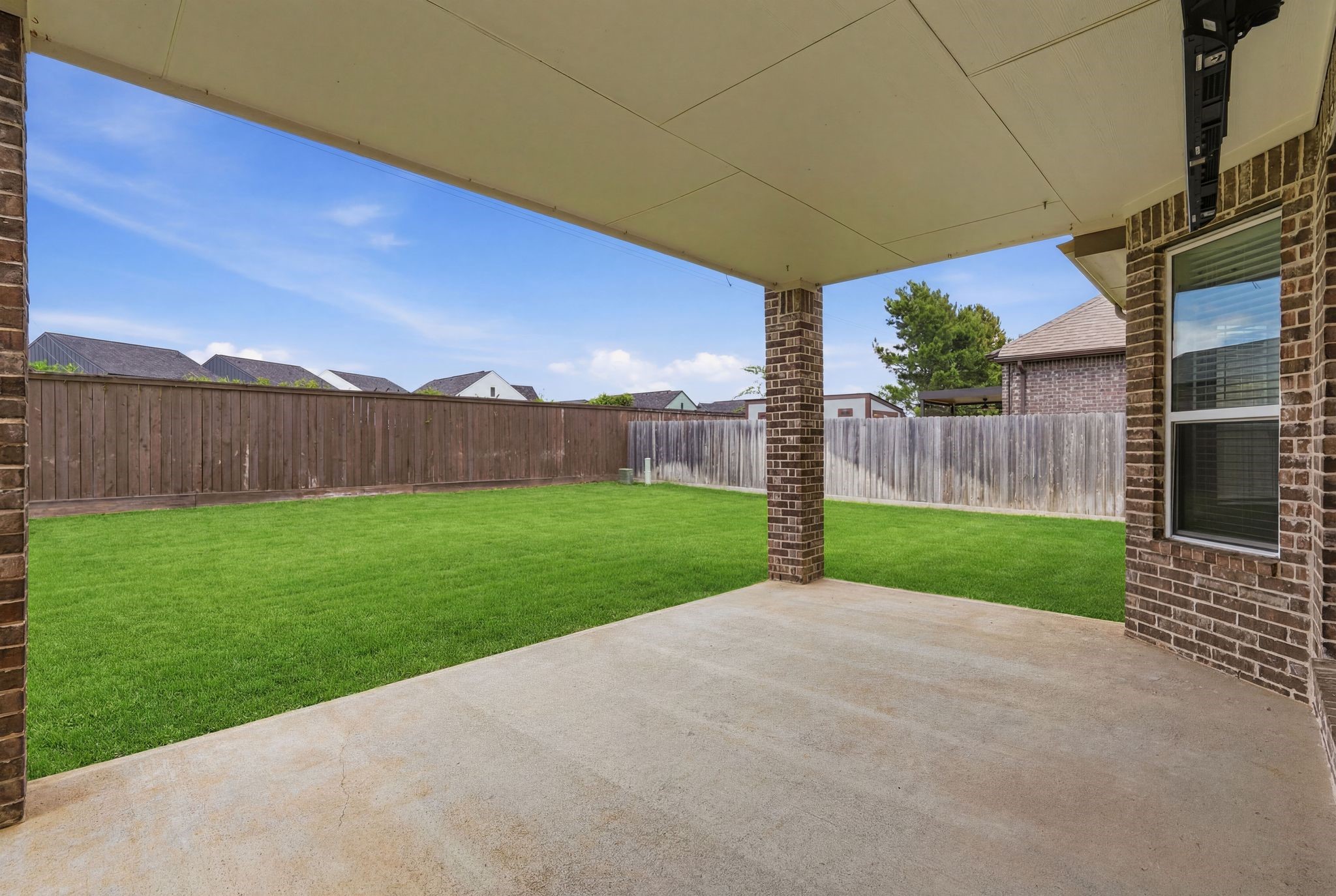 7522 Windsor View Drive Spring, TX 77379 - Photo 44 of 49 Covered patio overlooking the spacious backyard, creating a great spot to relax and unwind outdoors.