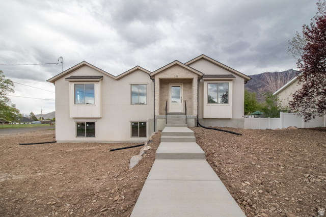 95 West 200 South Santaquin, UT 84655 - Photo 1 of 1 View of front of house with stucco siding and a mountain view