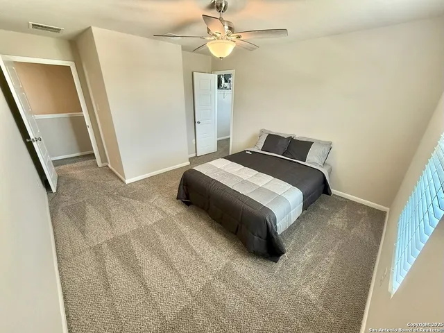 a bedroom with a bed and a walk in closet