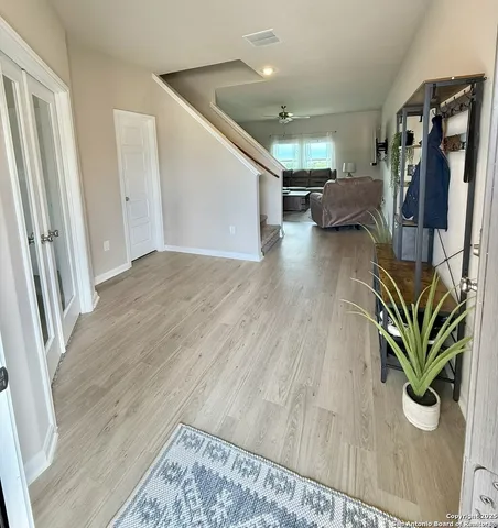 a view of entryway and hall with wooden floor