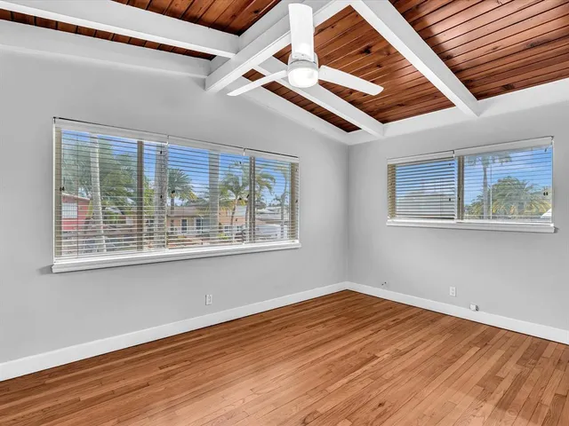 a dining room with stainless steel appliances furniture a rug and a kitchen view