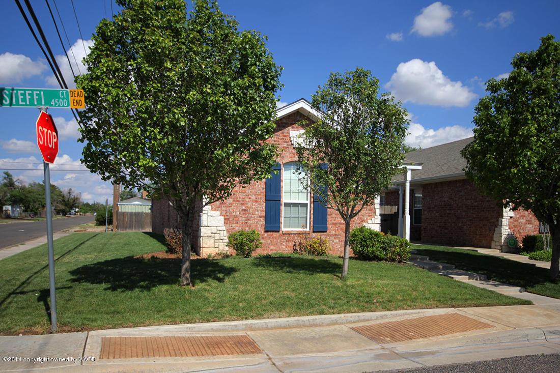 4501 Steffi Court Amarillo, TX 79110 - Photo 2 of 18 a front view of a house with a yard and garage