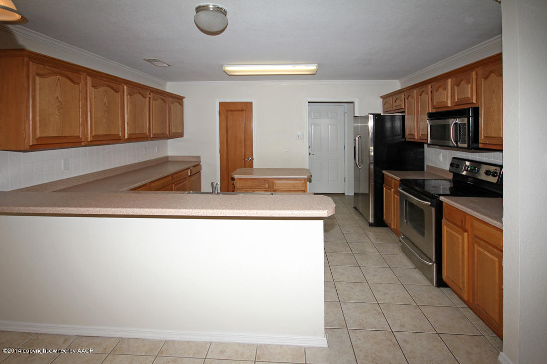 4501 Steffi Court Amarillo, TX 79110 - Photo 8 of 18 a kitchen with stainless steel appliances granite countertop a refrigerator and a stove top oven