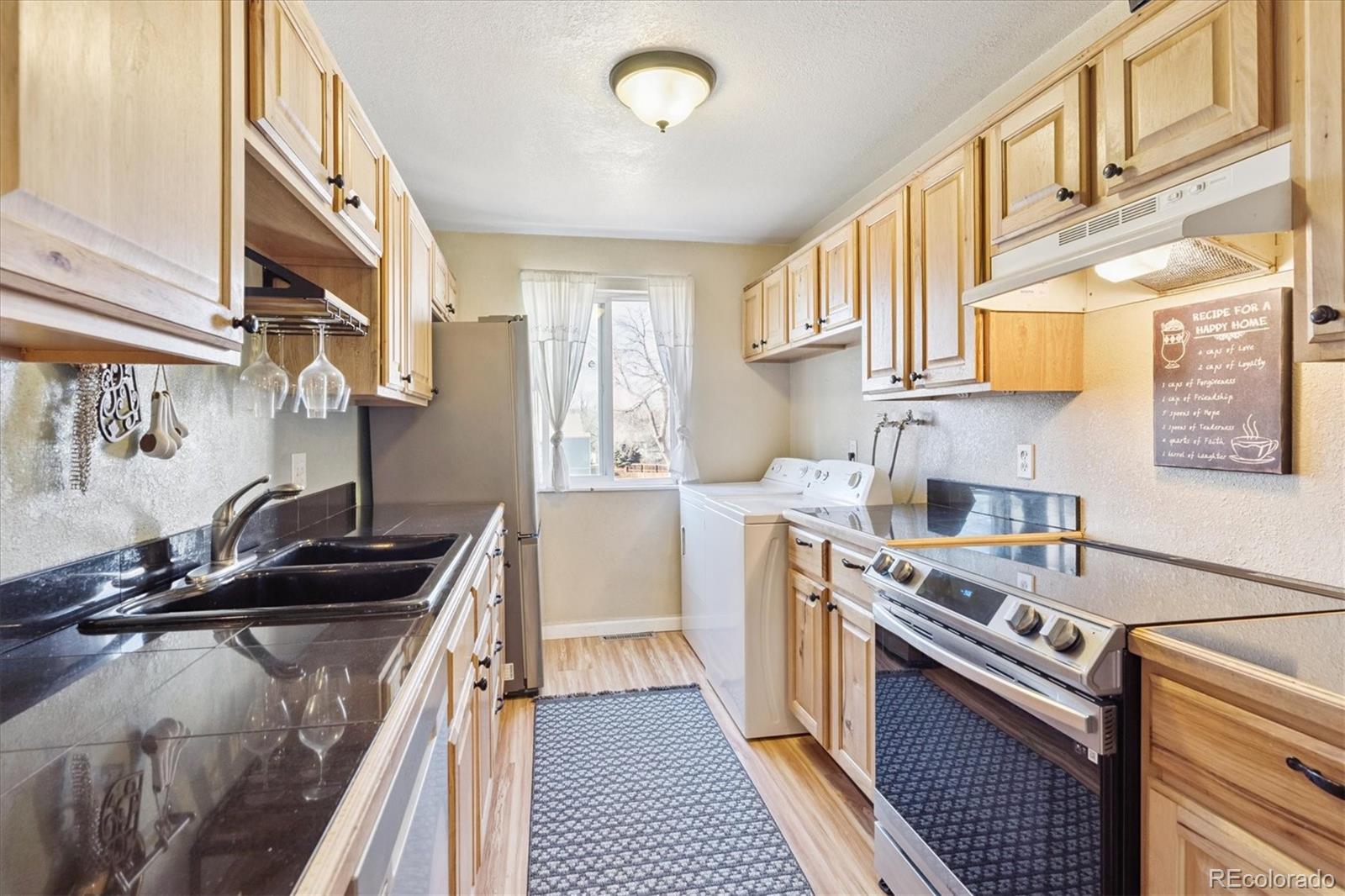 7984 Chase Circle, Unit 68 Arvada, CO 80003 - Photo 11 of 27 a kitchen with a sink a stove and cabinets
