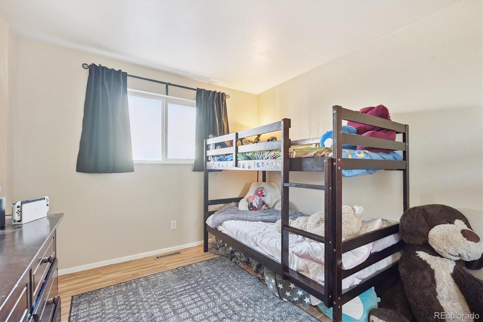 7984 Chase Circle, Unit 68 Arvada, CO 80003 - Photo 13 of 27 a bedroom with furniture and a window