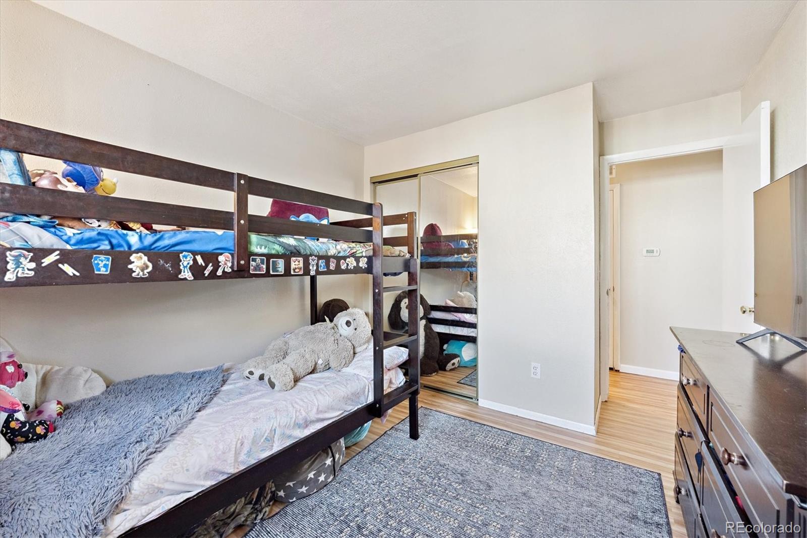 7984 Chase Circle, Unit 68 Arvada, CO 80003 - Photo 14 of 27 a bedroom with furniture and a bed