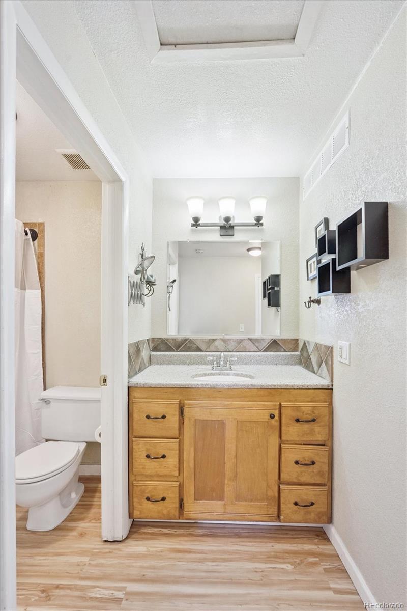 7984 Chase Circle, Unit 68 Arvada, CO 80003 - Photo 17 of 27 a room with a stove and a wooden floor