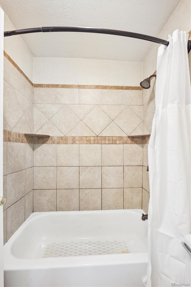 7984 Chase Circle, Unit 68 Arvada, CO 80003 - Photo 18 of 27 a bathroom with a bathtub and shower