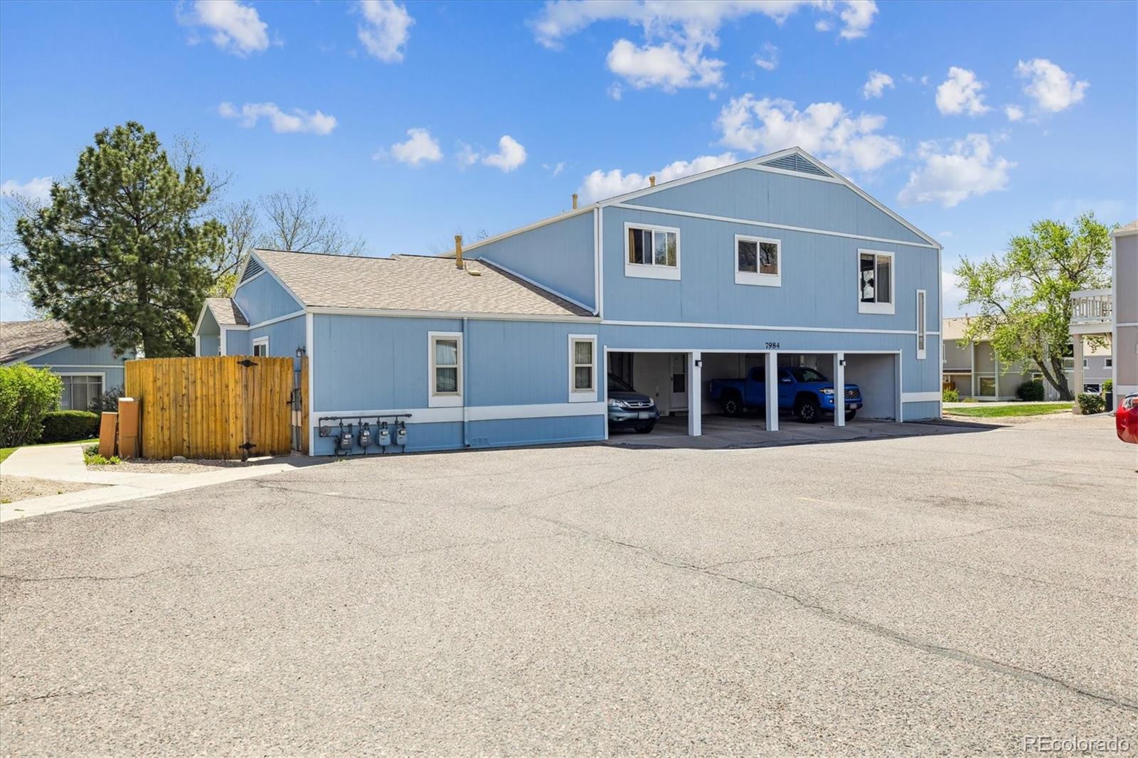 7984 Chase Circle, Unit 68 Arvada, CO 80003 - Photo 23 of 27 a front view of a house with a yard