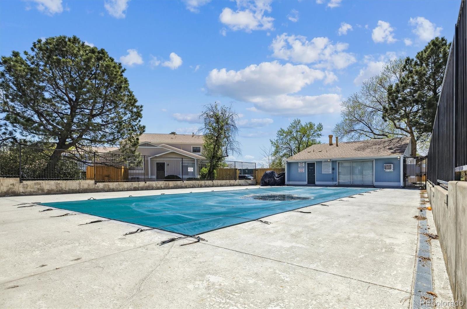 7984 Chase Circle, Unit 68 Arvada, CO 80003 - Photo 24 of 27 a front view of a house with a yard and garage
