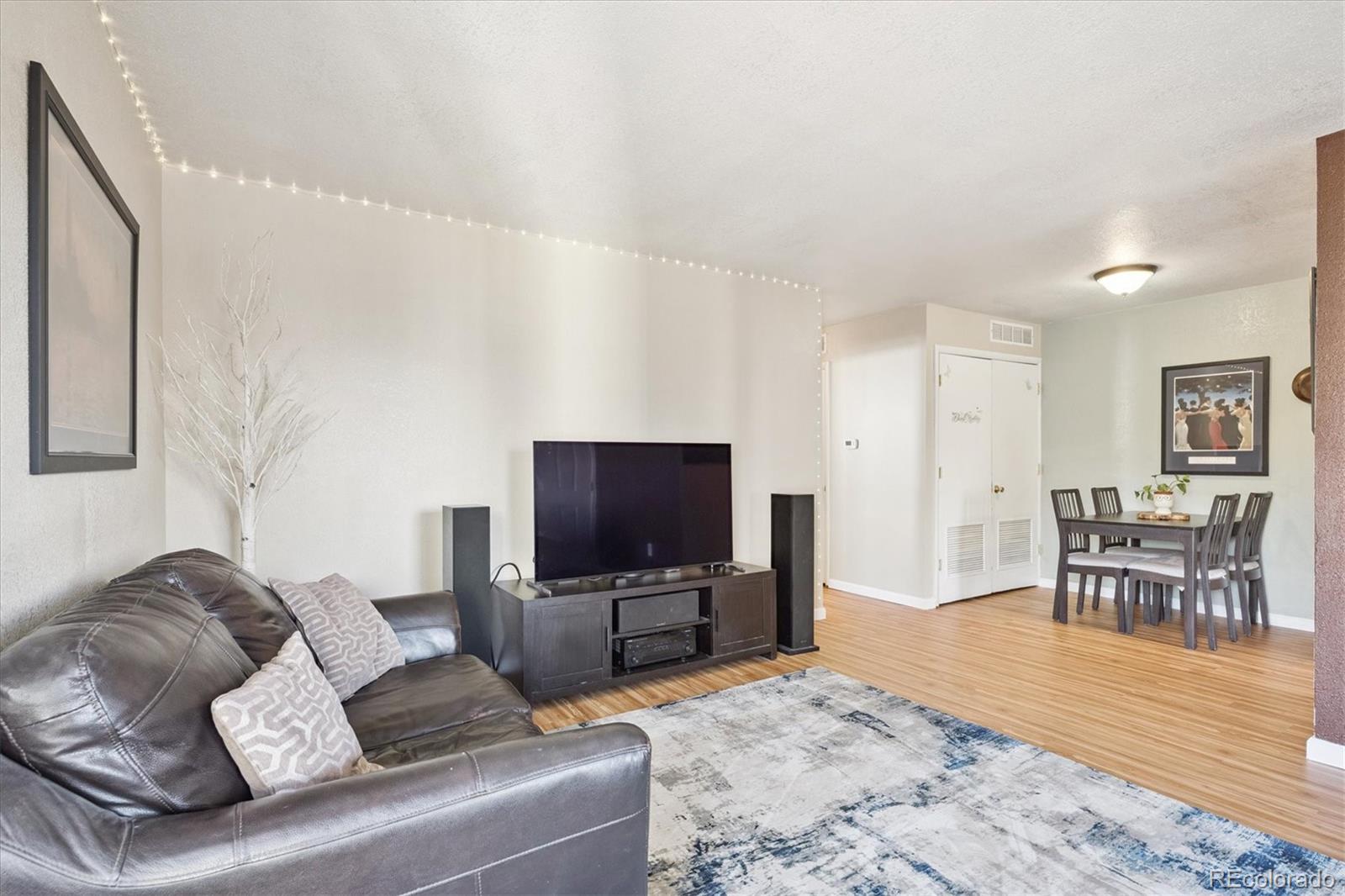 7984 Chase Circle, Unit 68 Arvada, CO 80003 - Photo 5 of 27 a living room with furniture and a flat screen tv
