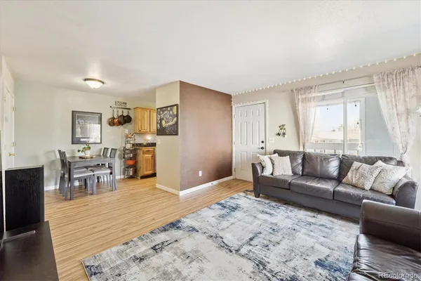 a living room with furniture and wooden floor