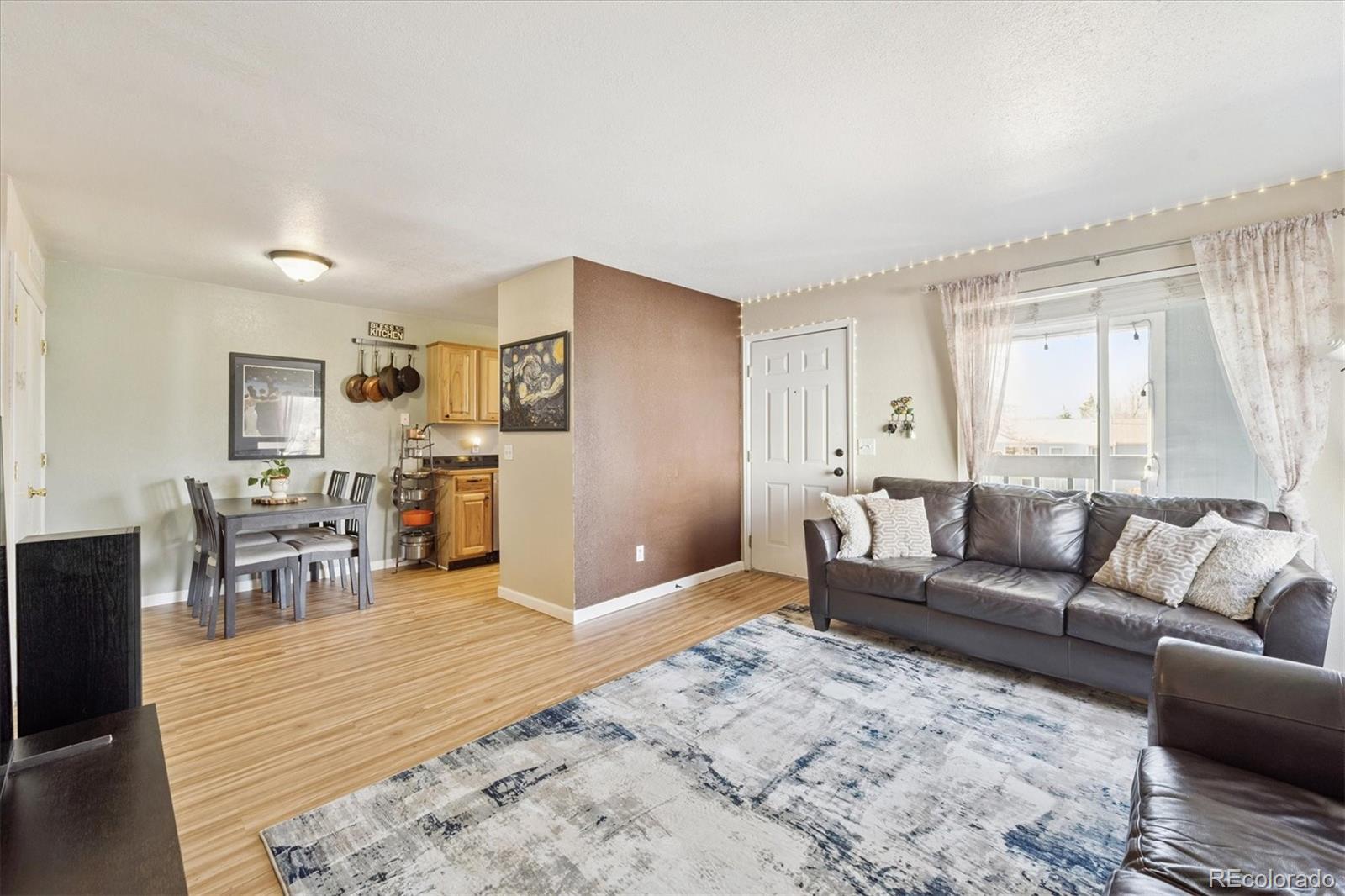 7984 Chase Circle, Unit 68 Arvada, CO 80003 - Photo 6 of 27 a living room with furniture and wooden floor
