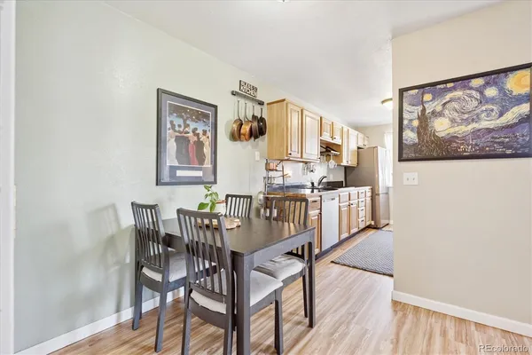 a view of a dining room with furniture and wooden floor