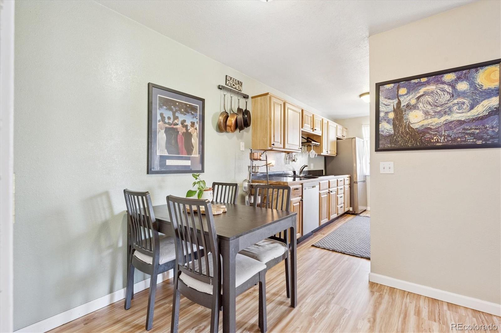 7984 Chase Circle, Unit 68 Arvada, CO 80003 - Photo 7 of 27 a view of a dining room with furniture and wooden floor