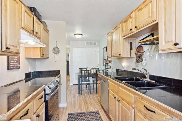 a kitchen with stainless steel appliances granite countertop a stove and a sink
