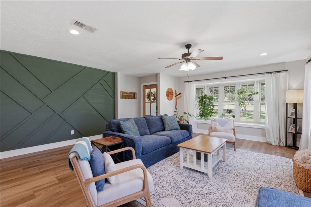 515 Crescent Drive Bryan, TX 77801 - Photo 8 of 43 Spacious living area featuring a decorative accent wall and a large bay window