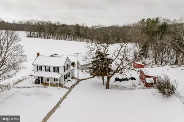 a view of a town with snow on the road