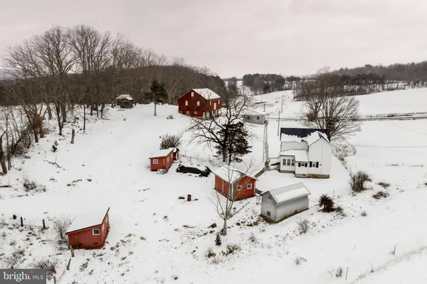 a front view of a house with a yard covered in snow