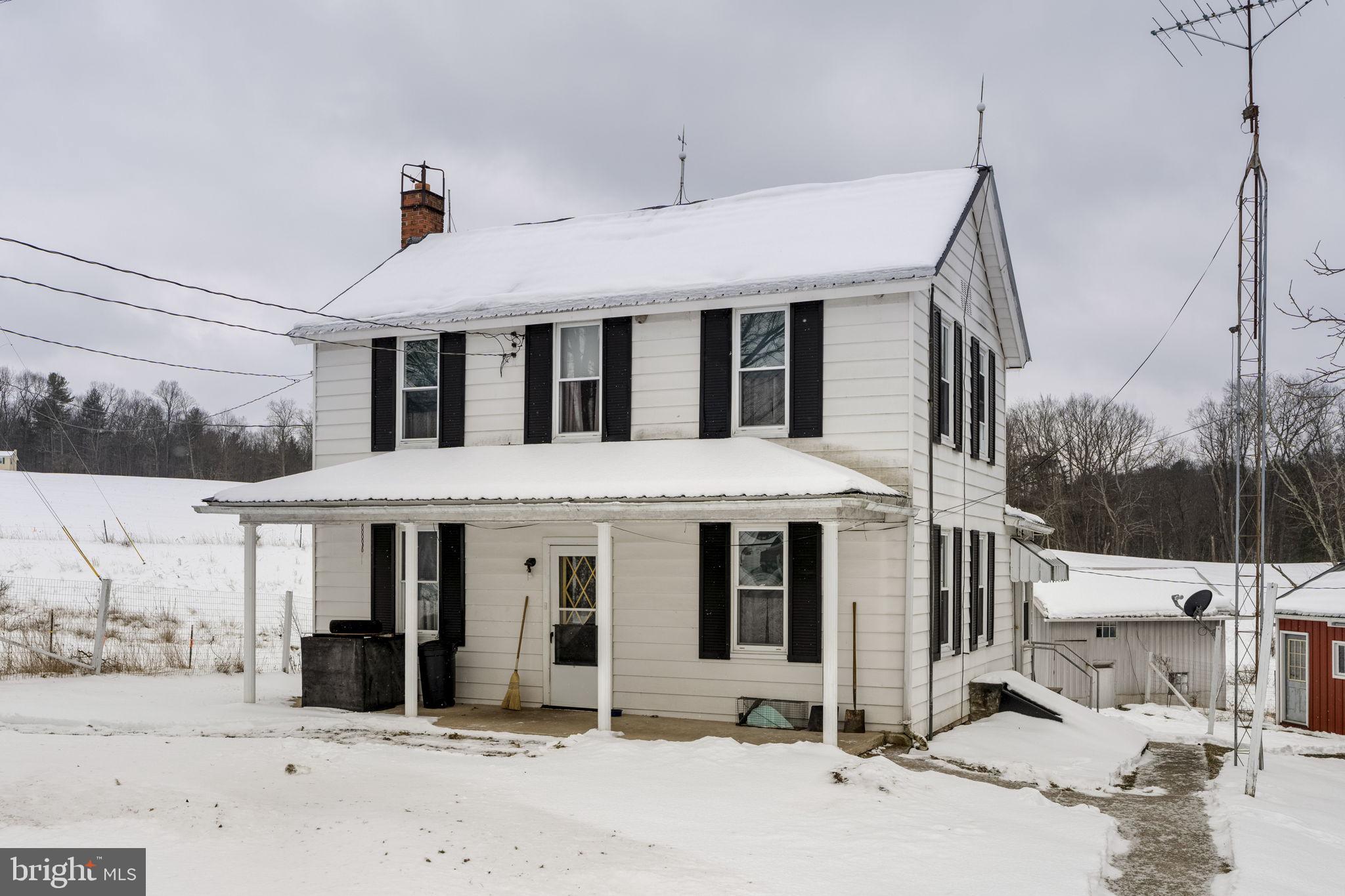 22314 Miller Road Shade Gap, PA 17255 - Photo 15 of 73 a front view of a house with a yard covered in snow