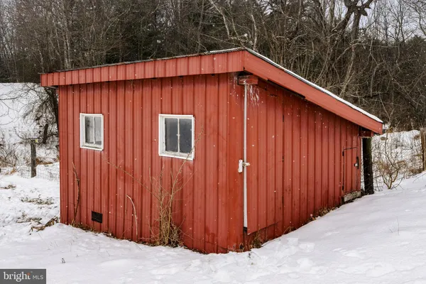 a bathroom with a sink vanity granite toilet and a mirror