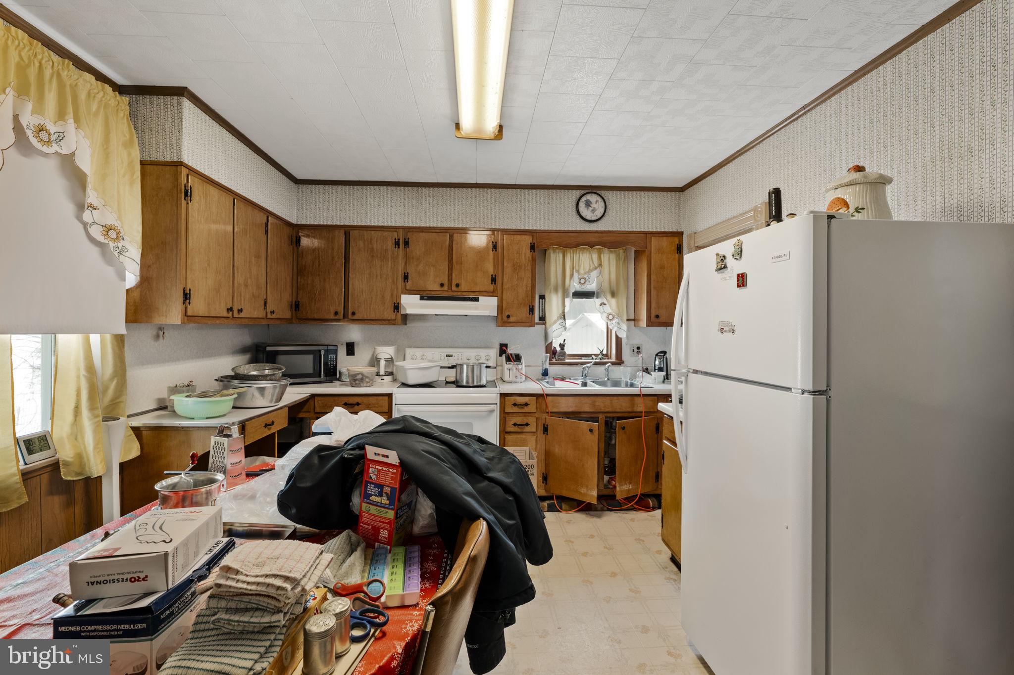 22314 Miller Road Shade Gap, PA 17255 - Photo 39 of 73 a kitchen with a refrigerator and a stove top oven