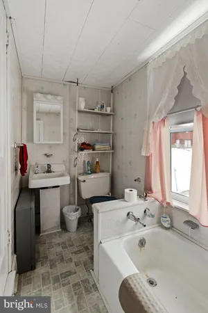 a view of a porch with a table and chairs