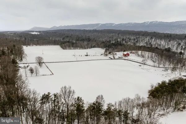 a view of a house with a yard and covered with snow