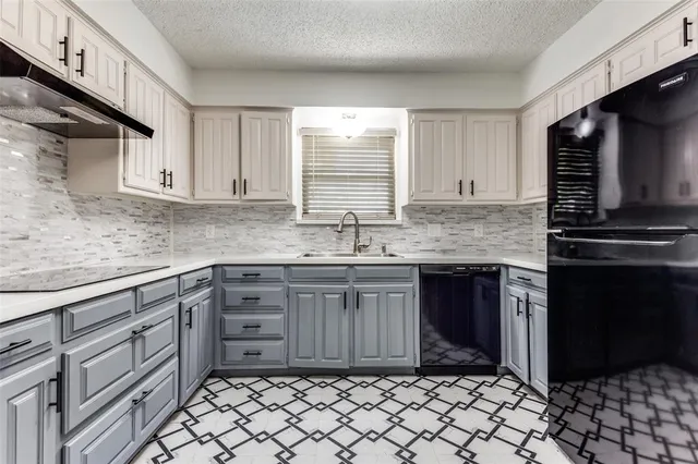 a kitchen with stainless steel appliances granite countertop a sink stove and cabinets