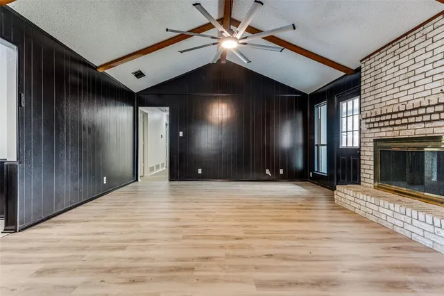 a view of an empty room with a fireplace