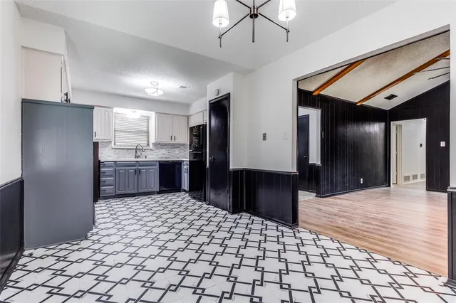 a kitchen with stainless steel appliances kitchen island granite countertop a refrigerator and a sink