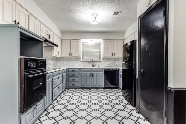 a kitchen with stainless steel appliances a refrigerator sink and cabinets