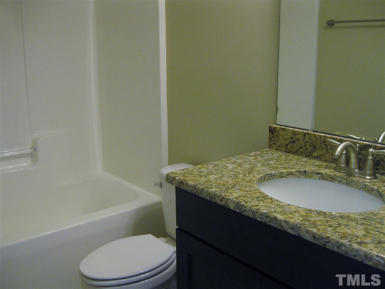 8044 Creech Road Middlesex, NC 27557 - Photo 13 of 14 The bath upstairs also offers granite countertops as well as a linen closet.