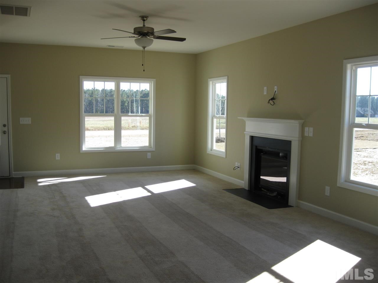 8044 Creech Road Middlesex, NC 27557 - Photo 3 of 14 Light pours into this huge living room! It also has a gas log fireplace as well as a ceiling fan!