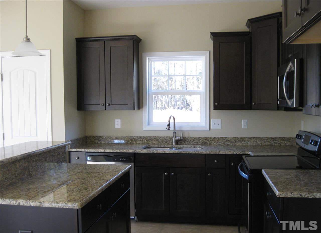 8044 Creech Road Middlesex, NC 27557 - Photo 6 of 14 The Stunning kitchen offers dark cabinetry, granite countertops, stainless steel appliances and recessed lighting. There is also a pantry which offers plenty of storage!