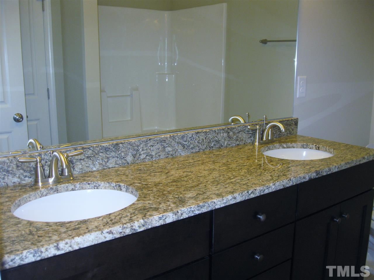 8044 Creech Road Middlesex, NC 27557 - Photo 10 of 14 The master bath offers a dual vanity with granite countertops. It also has a garden tub with shower and a large linen closet.