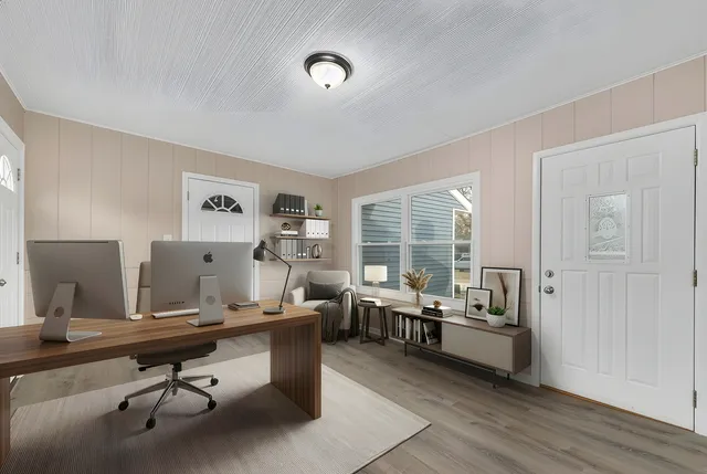 a workspace with furniture and a large window