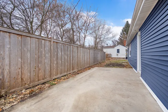 a view of a backyard with wooden fence