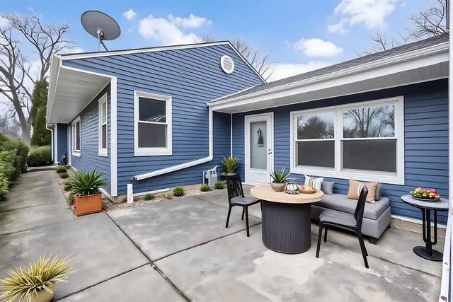 a table and chairs in front of a house