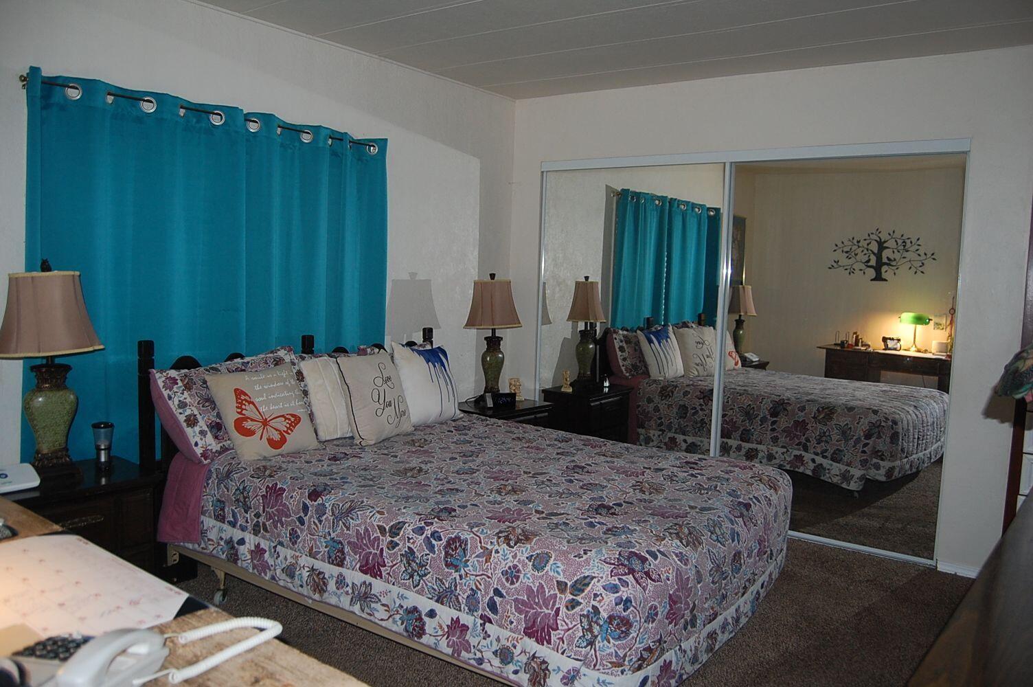 350 Hamilton Avenue Cave Junction, OR 97523 - Photo 11 of 23 a bedroom with a large bed and a dresser