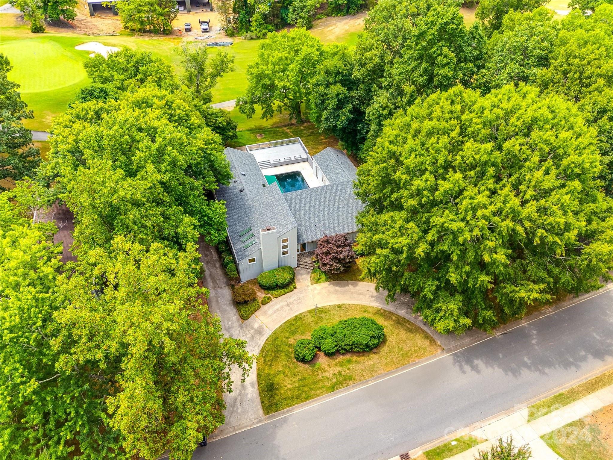 an aerial view of a house with a yard basket ball court and outdoor seating