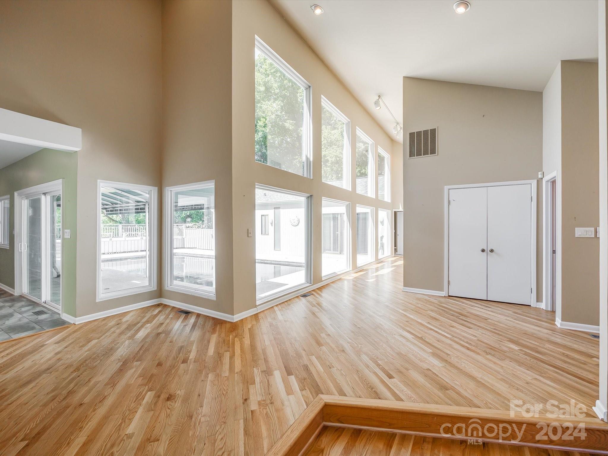 4001 Rounding Run Road Charlotte, NC 28277 - Photo 7 of 42 a view of an empty room with wooden floor and a window
