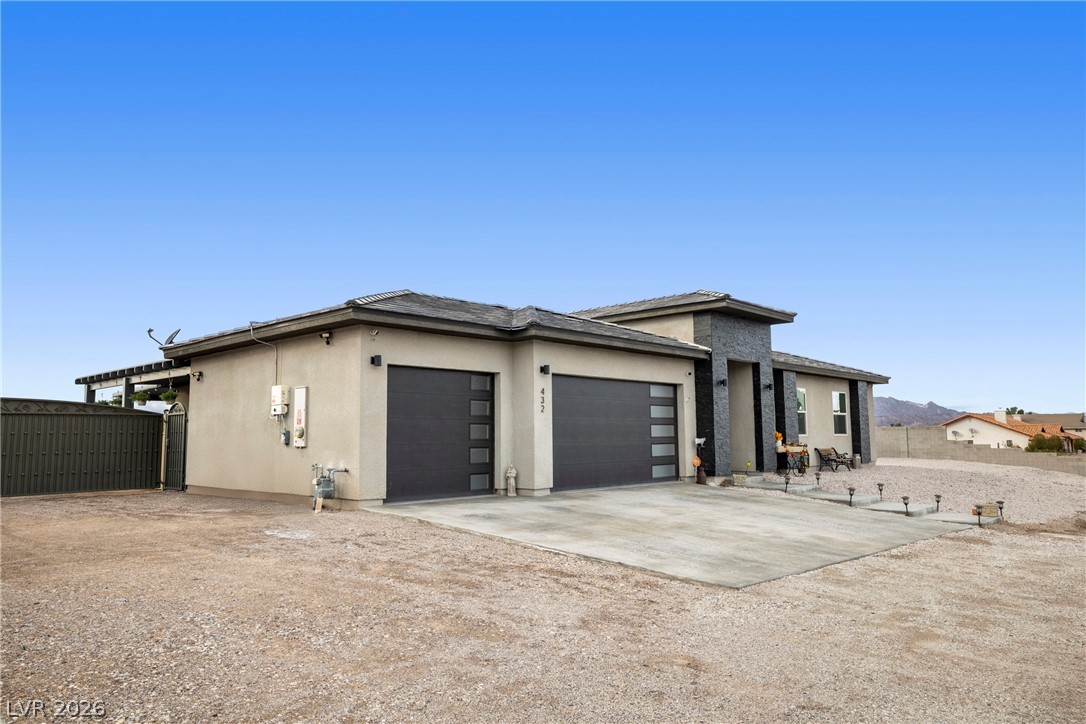 432 North Racetrack Road Henderson, NV 89015 - Photo 43 of 45 Prairie-style house featuring stucco siding, concrete driveway, and an attached garage