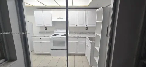a kitchen with a stove cabinets and counter space