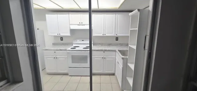 a kitchen with a stove cabinets and counter space