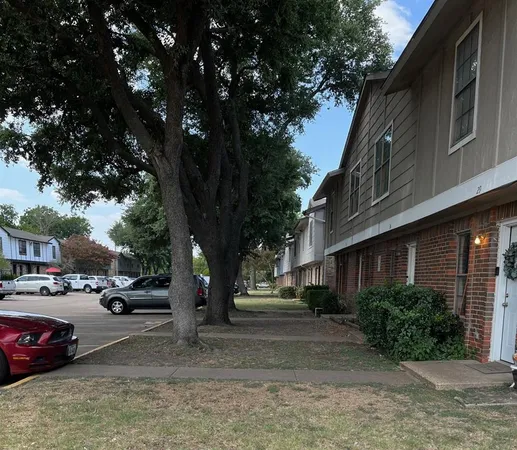 a street view with couple of cars parked on road
